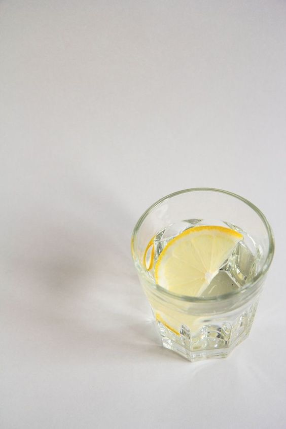 Key 2 Wellness - A glass of water with a slice of lemon for wellness.